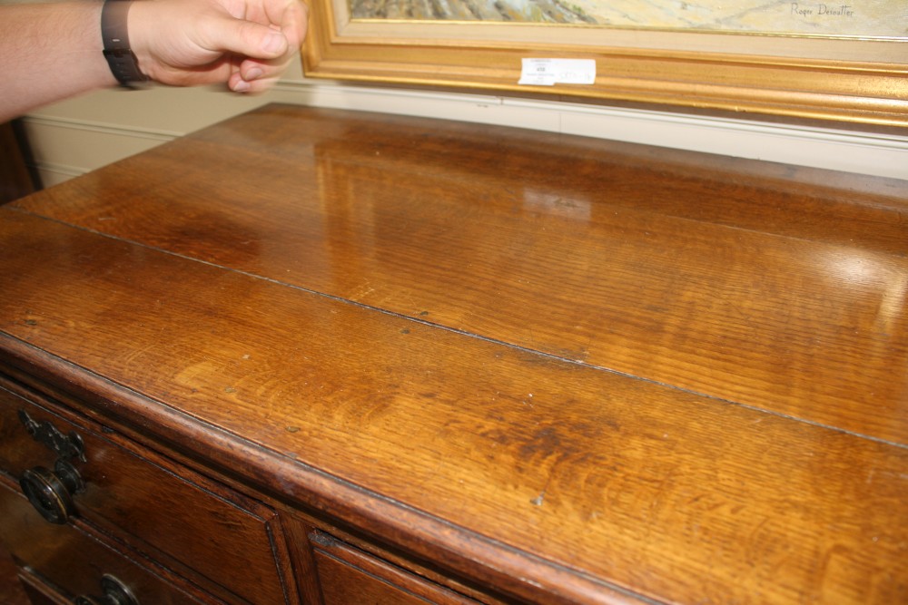 A 19th century panelled oak chest of drawers, W.103cm D.56cm H.112cm